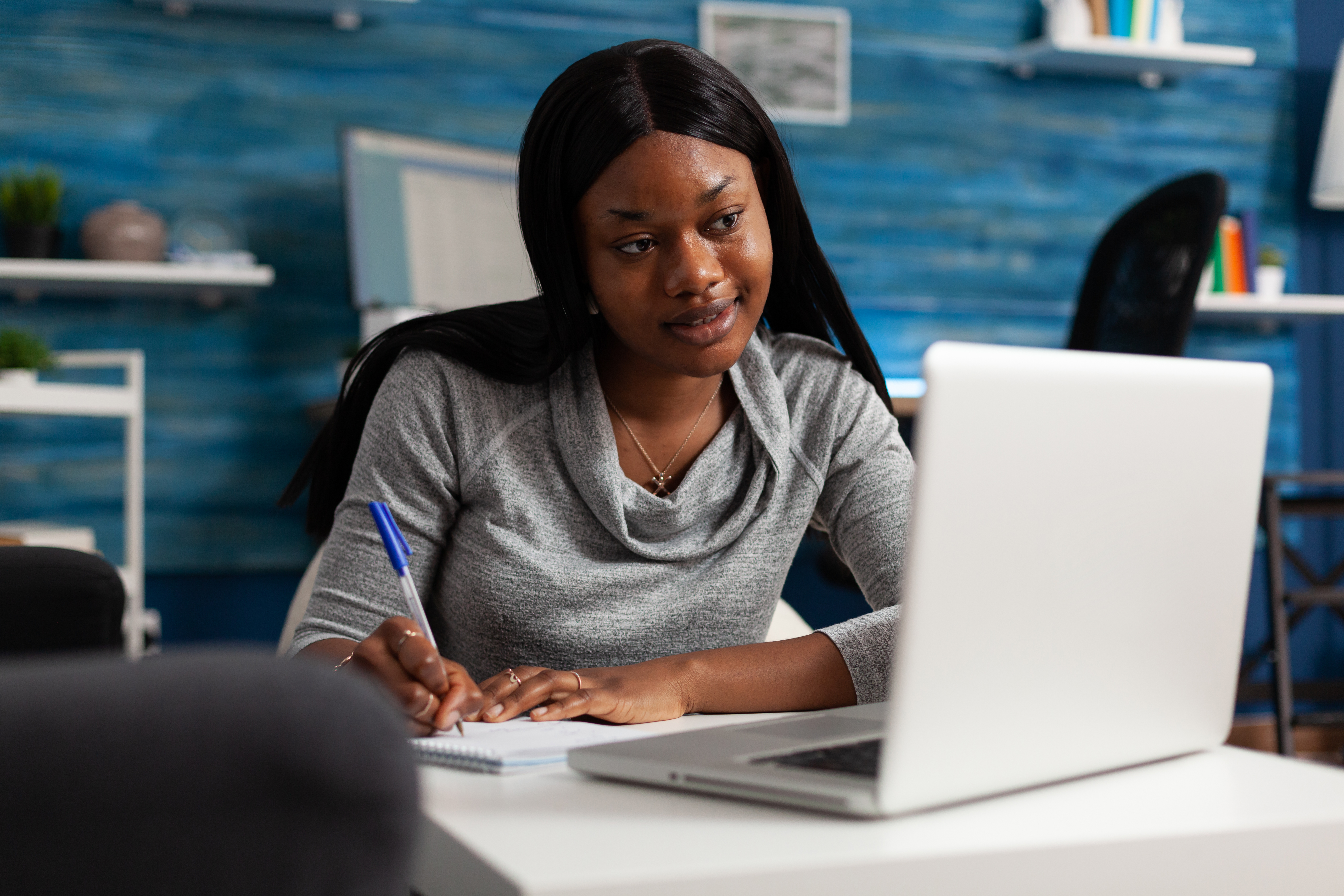 Happy woman learning on laptop